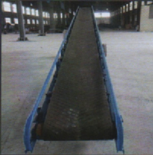 Long belt conveyor running the length of a factory floor